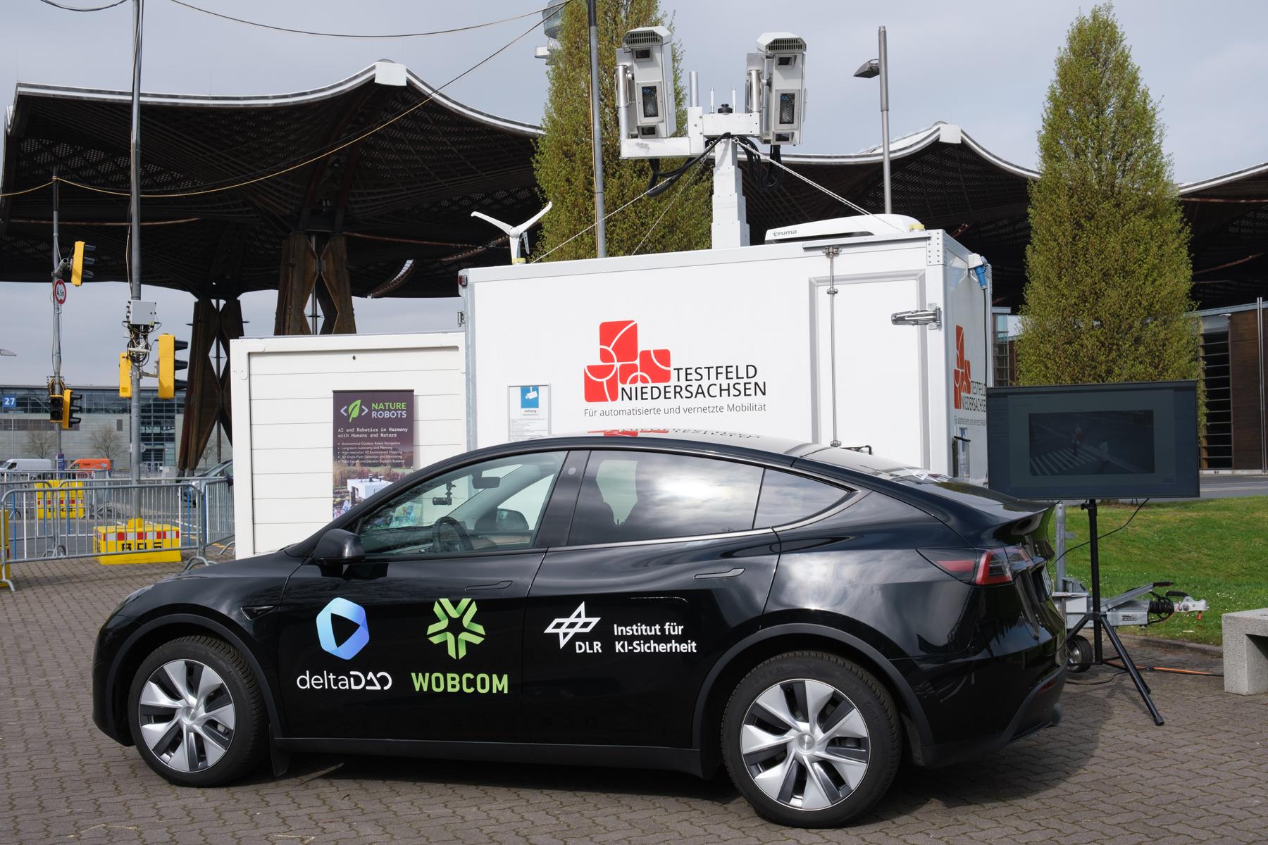Mobile Messstation des Testfeld Niedersachsen. Ein Container mit Kameras, davor ein Auto.